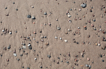 Fototapeta na wymiar Sand and different stone pebbles as background. 