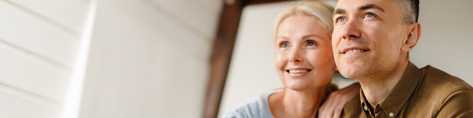 Smiling middle aged couple standing together