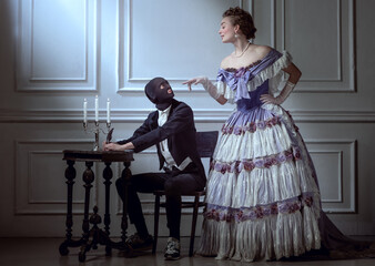 Vintage renaissance style. Young beautiful woman in image of medieval royal person in evening dress...