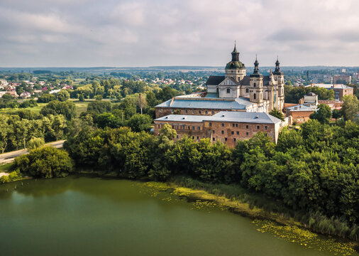 Aerial spring view of Monastery of the Bare Carmelites and lake in front of it. Berdychiv, Travel destinations across Ukraine
