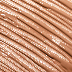 Liquid concealer face cream background smear smudge swatch macro. Makeup foundation shades for beauty catalog. Nude cosmetic BB cream liquid foundation moisturizer. Beige color
