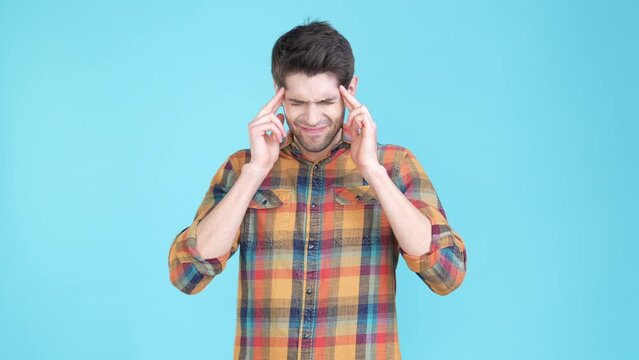 Overwhelmed guy suffer severe headache isolated blue color background