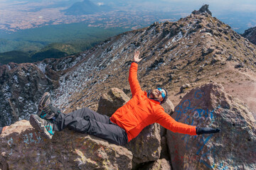 hiker taking a break resting on a rock