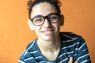 teenager smiling at the camera with a happy and confident expression