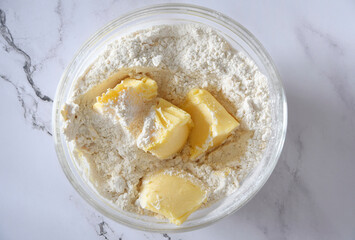 Butter and flour in a bowl, ingredients for making shortbread cookies at home