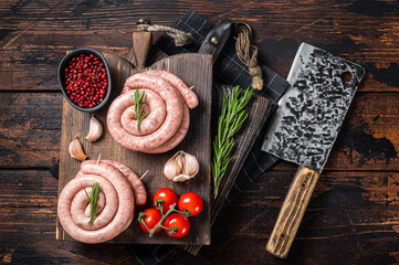 Bavarian Raw spiral sausages on a wooden board. Wooden background. Top view