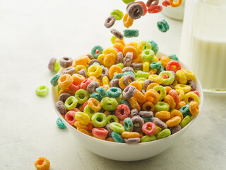 Close-up. Large bowl with multi-colored crunchy fruit rings. Levitation. White background. Express breakfasts, healthy food, sports, fitness, diet, baby food. Supermarket. cafe advertising.