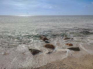 wave hitting the stones on a beach