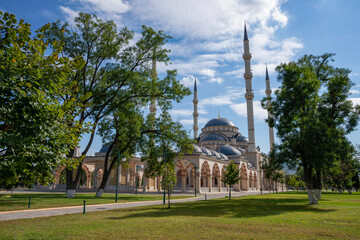 Fototapeta na wymiar View of the Tashu-Hajji Mosque from the park on a sunny September day. Chechen Republic, Gudermes, Russia
