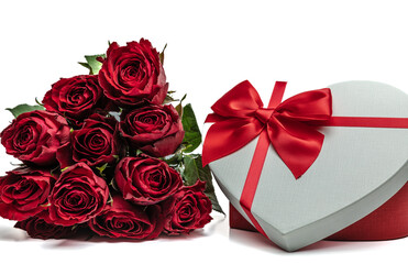 12 red roses and a heart shaped gift box on a white background with copy space.