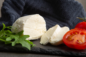 Fresh tasty mozzarella close-up. Concrete grey background.