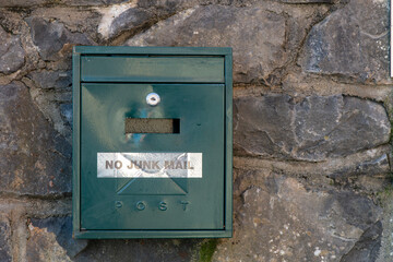 mailboxes embedded in a stone wal