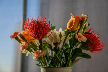 Red, Orange, Pink, and White Flowers in Vase