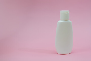 White plastic tube on pink background. Сosmetic bottles for beauty or medicine products
