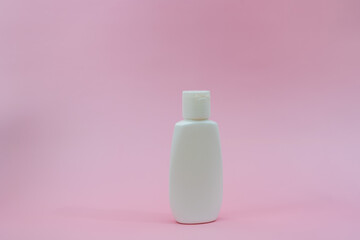 White plastic tube on pink background. Сosmetic bottles for beauty or medicine products