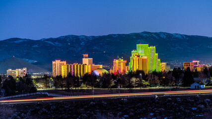 City of Reno downtown Cityscape at dusk with light trails from the traffic on the street in front...