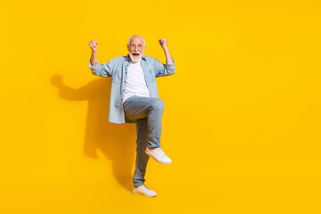 Fototapeta na wymiar Full length body size view of attractive funky cheerful grey-haired man rejoicing great news isolated over bright yellow color background