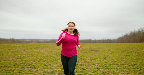 Fitness millennial woman running in beautiful nature. Healthy lifestyle, Weight loss concept