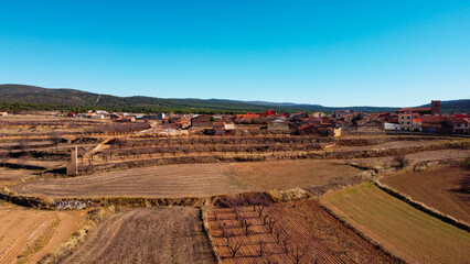 Aerial view with drone of a town in Spain, you can see fields and a road