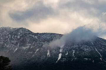 Foggy Snowy Mountains. Magical atmosphere of a foggy morning in a mountain. Copy paste banner space.	