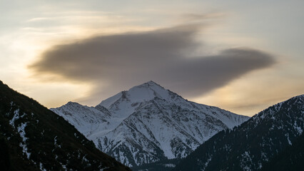 Cloudy dawn over a mountain peak