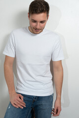 Fototapeta premium Handsome young guy with beard looking at camera, posing on white background.