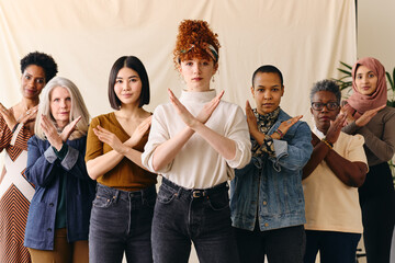 Young white woman gesturing Break The Bias in support of International Women's Day with female...