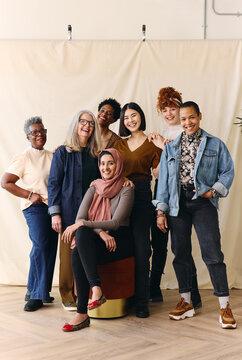 Portrait of mixed age range multi ethnic women smiling in celebration of International Women's Day