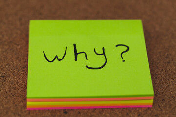 Why? written on a green note paper , Business Concept