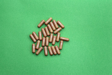 Vitamins on a green background. Capsules