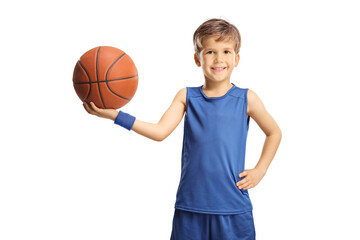 Smiling boy in a blue jersey holding a basketball
