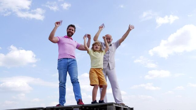 Happy family winners with paper planes enjoy success making winning gesture sky-high, victory