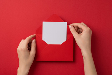 First person top view photo of valentine's day decorations female hands taking letter out of red...