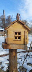 Bird house with snow in winter.