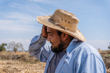 portrait of a Mexican happy farmer collecting corn