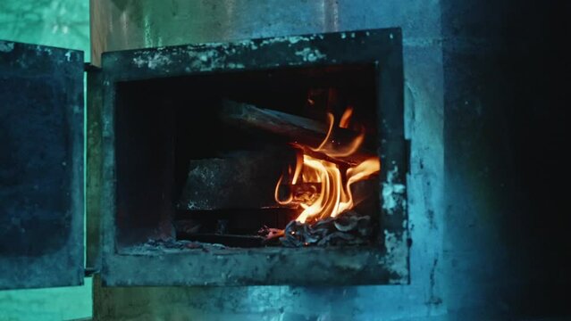 Flame of fire in fireplace. Preparing place for cooking pilaf for big refugees family.
