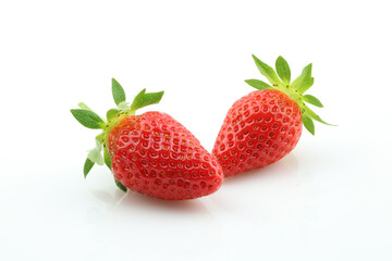 Two strawberries close up on white background. Fresh ripe whole strawberries.