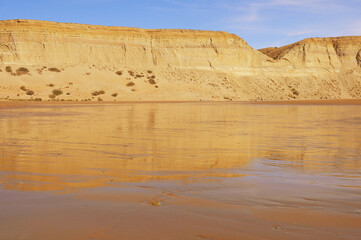 Cliffs by the beach of Pacific ocean. Puerto Santa Cruz.