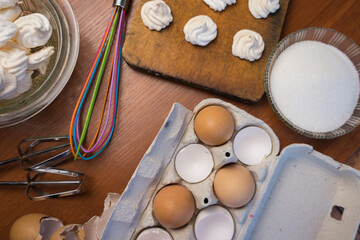 Fototapeta na wymiar Delicious crispy homemade egg meringue, prepared with love on a wooden background, crunchy dessert for coffee or tea.