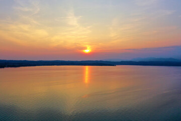 Sunrise over Lake Garda. Reflection of the morning sun in the water.