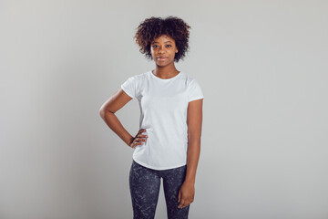 Fototapeta na wymiar African american woman with puffy hair in a white t-shirt on a white background. Mock-up.
