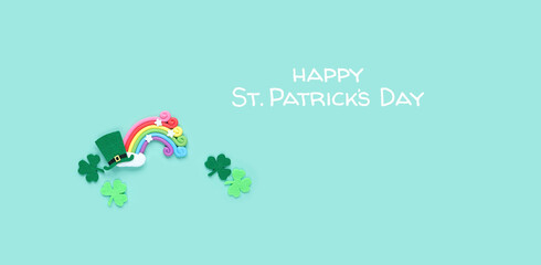 happy St. Patrick’s Day greeting card. decorative clover leaves, toy rainbow and leprechaun hat...