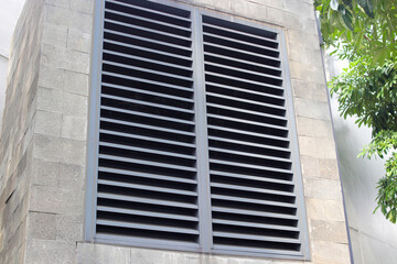 Lattice shutters vent cover on the wall in a shopping center building