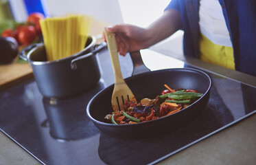 Young woman in the kitchen preparing a food