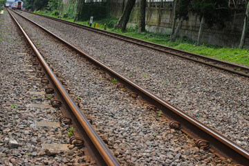 Obraz premium Rusty train tracks with pebbles in Indonesia railways