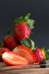 cutting strawberries on a kitchen board