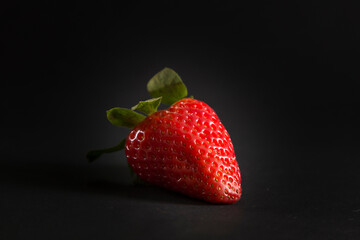 deep red strawberry on black background