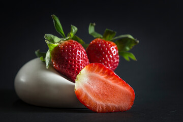 strawberries served in an original way, in the foreground half a strawberry