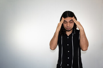 portrait of a hispanic man with a headache, stress and frustration on a white background