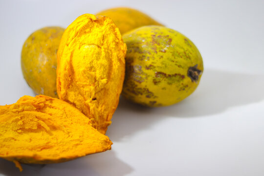 a group of ripe yellow egg fruit or canistel (commonly known as the cupcake fruit, Pouteria campechiana, Sawo mentega, sawo ubi, sawo belanda, alkesah) isolated on white background.